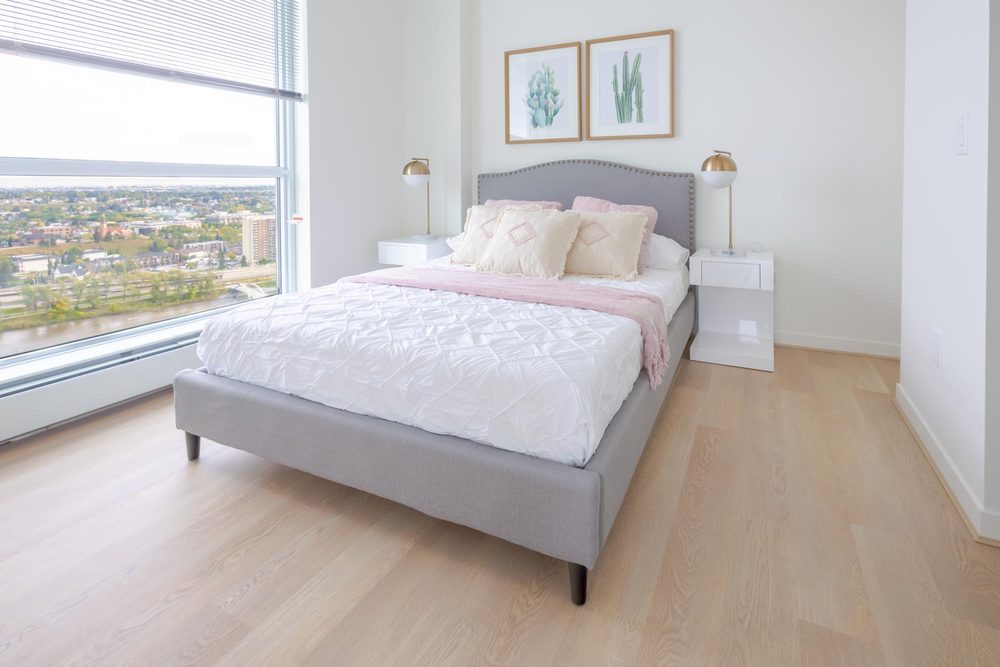 Bedroom with floor-to-ceiling windows over the city
