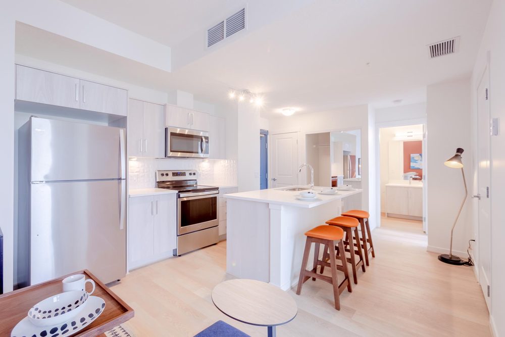 Kitchen with an island and orange stools