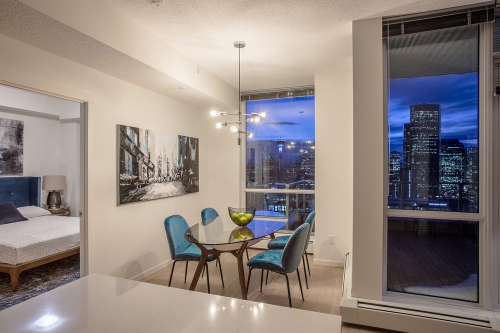 Dining nook at night, downtown lit up beyond