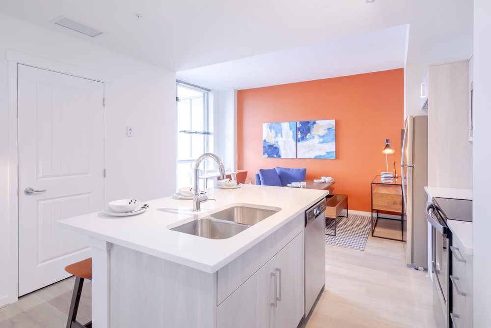 Kitchen island with a feature wall beyond