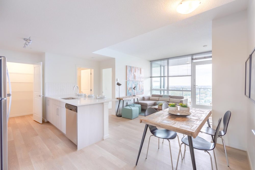 Kitchen and dining area with a balcony beyond